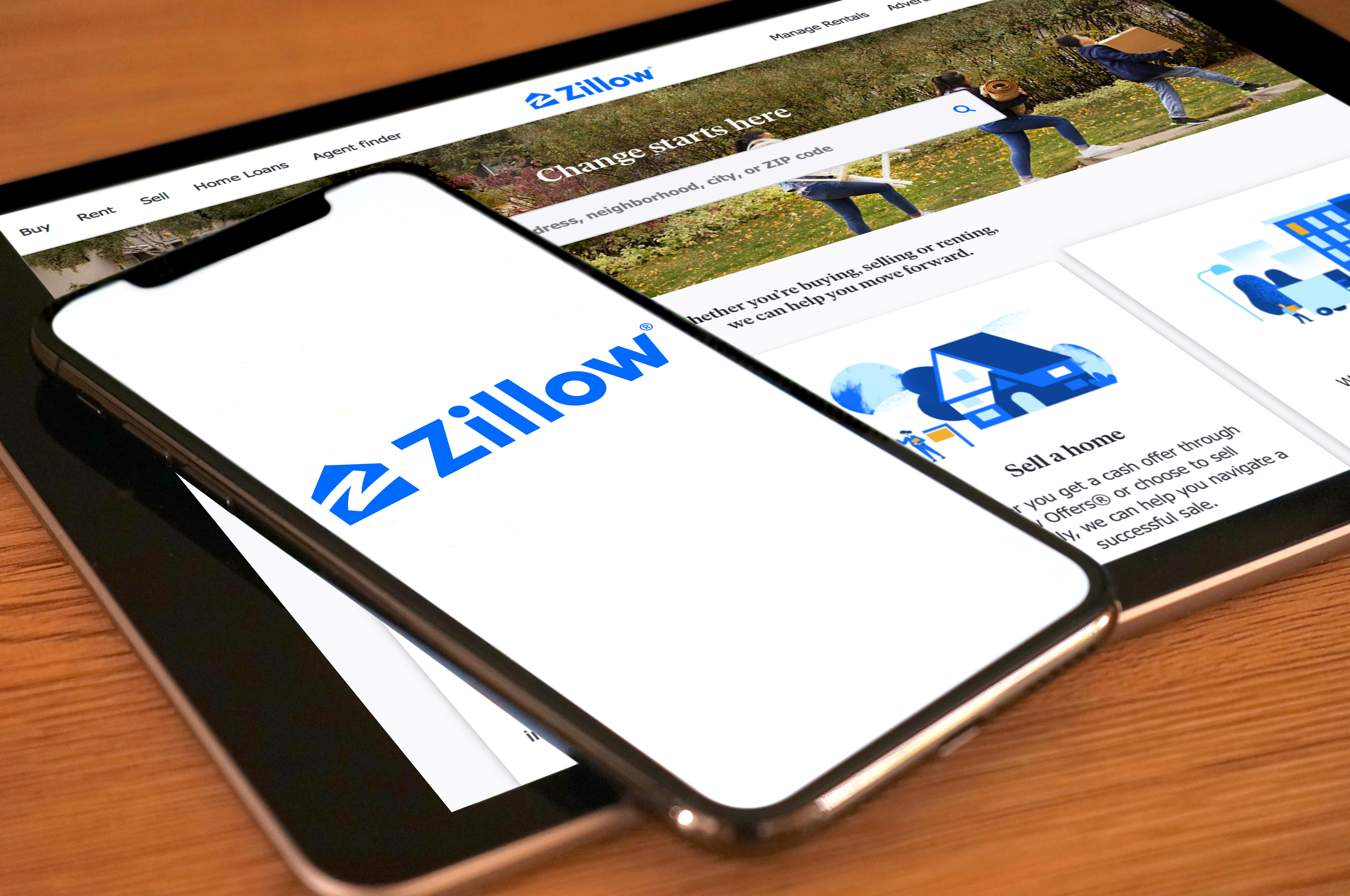 Close-up of a smartphone and tablet displaying the Zillow website and app, representing online property searches, rental estimates, and digital real estate tools.