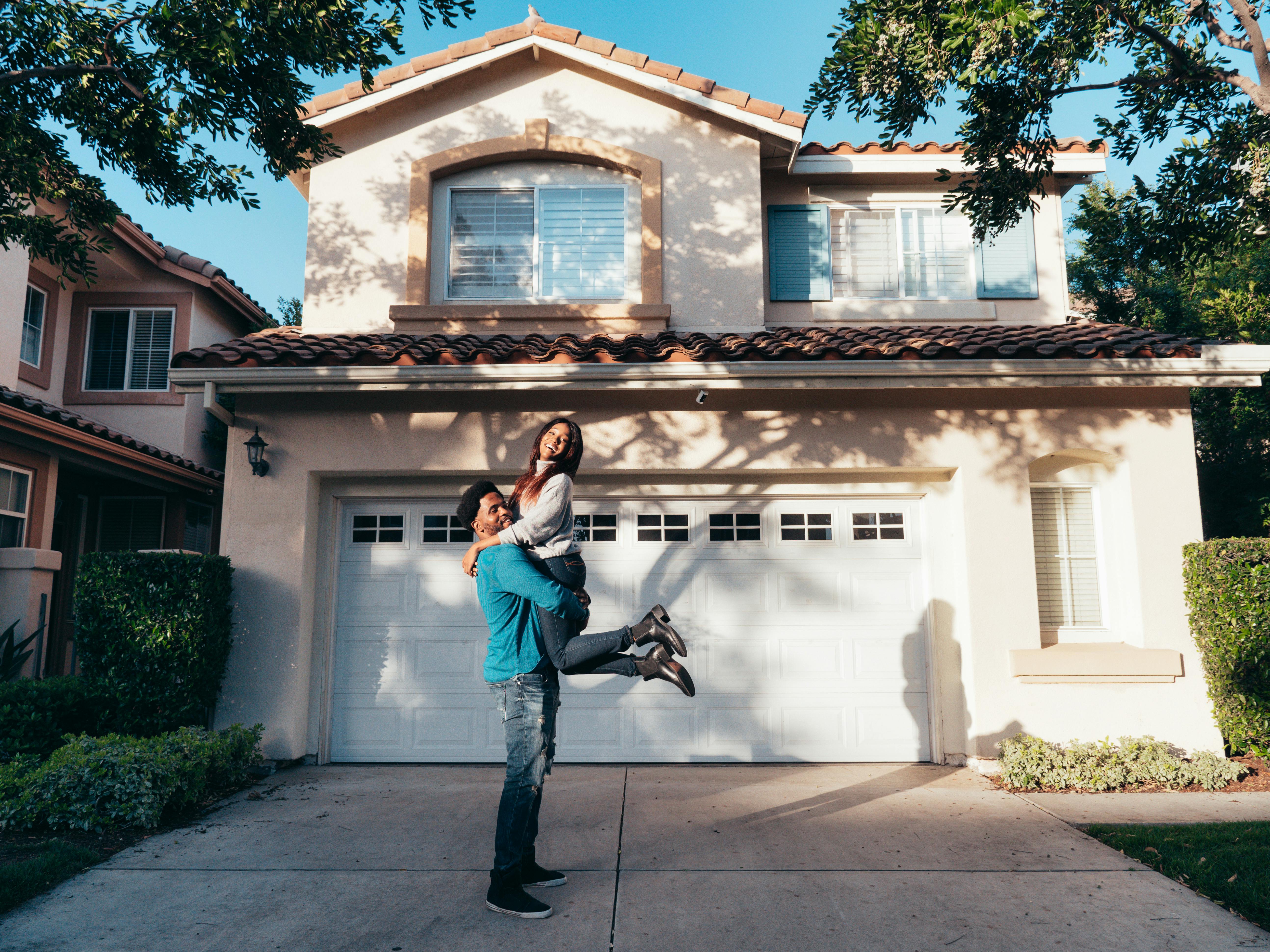 People Standing in Front of their House