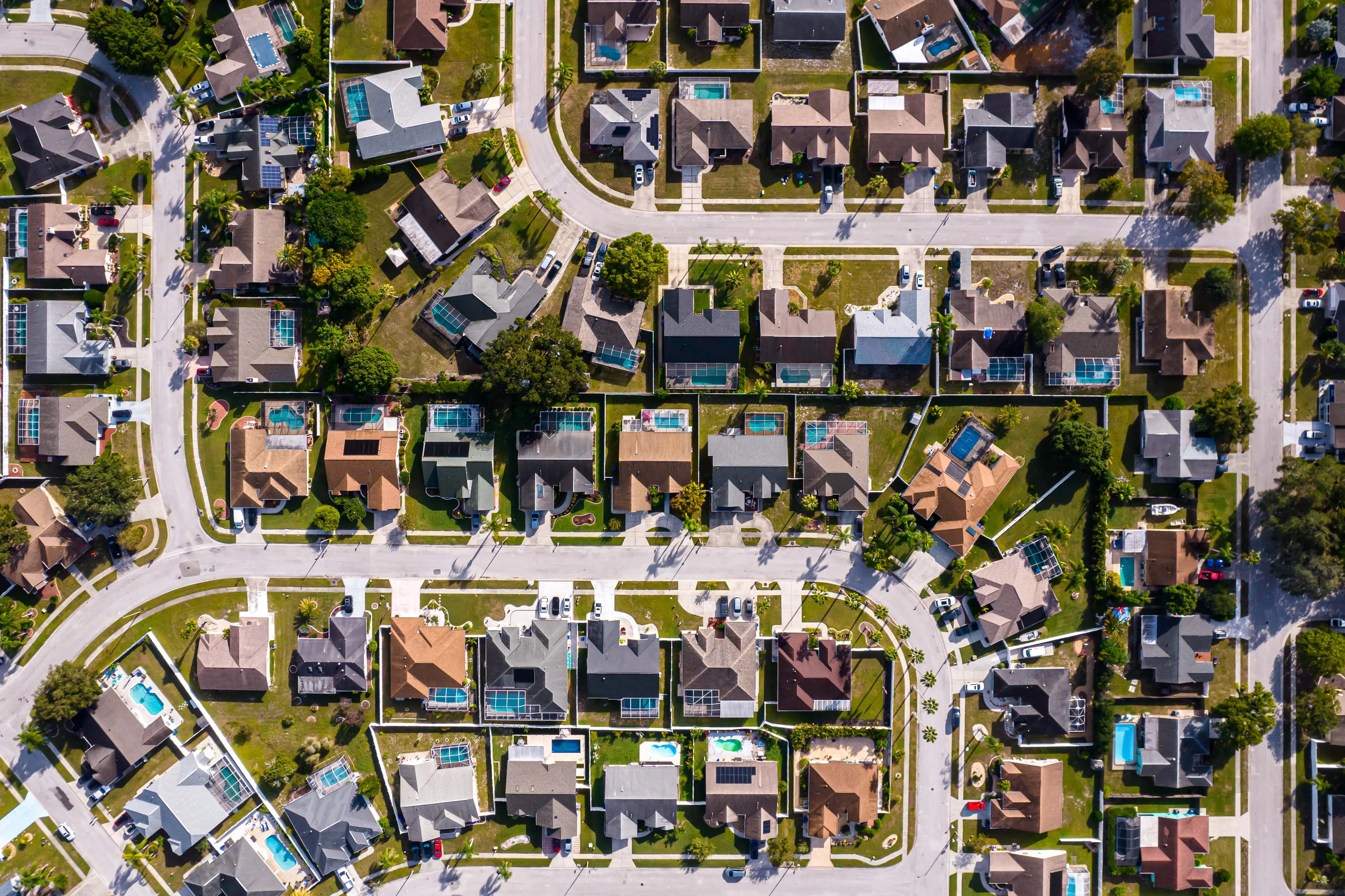 Grid-style aerial photo of suburban homes with pools, symbolizing planned communities and investment properties in Central Florida.