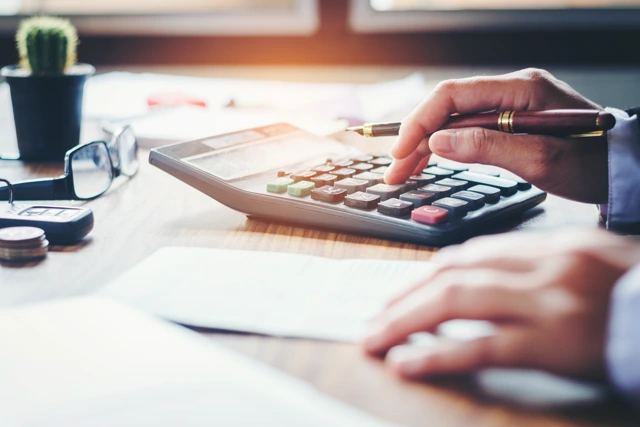 Property owner calculating rental income and expenses for Central Florida investment property management.