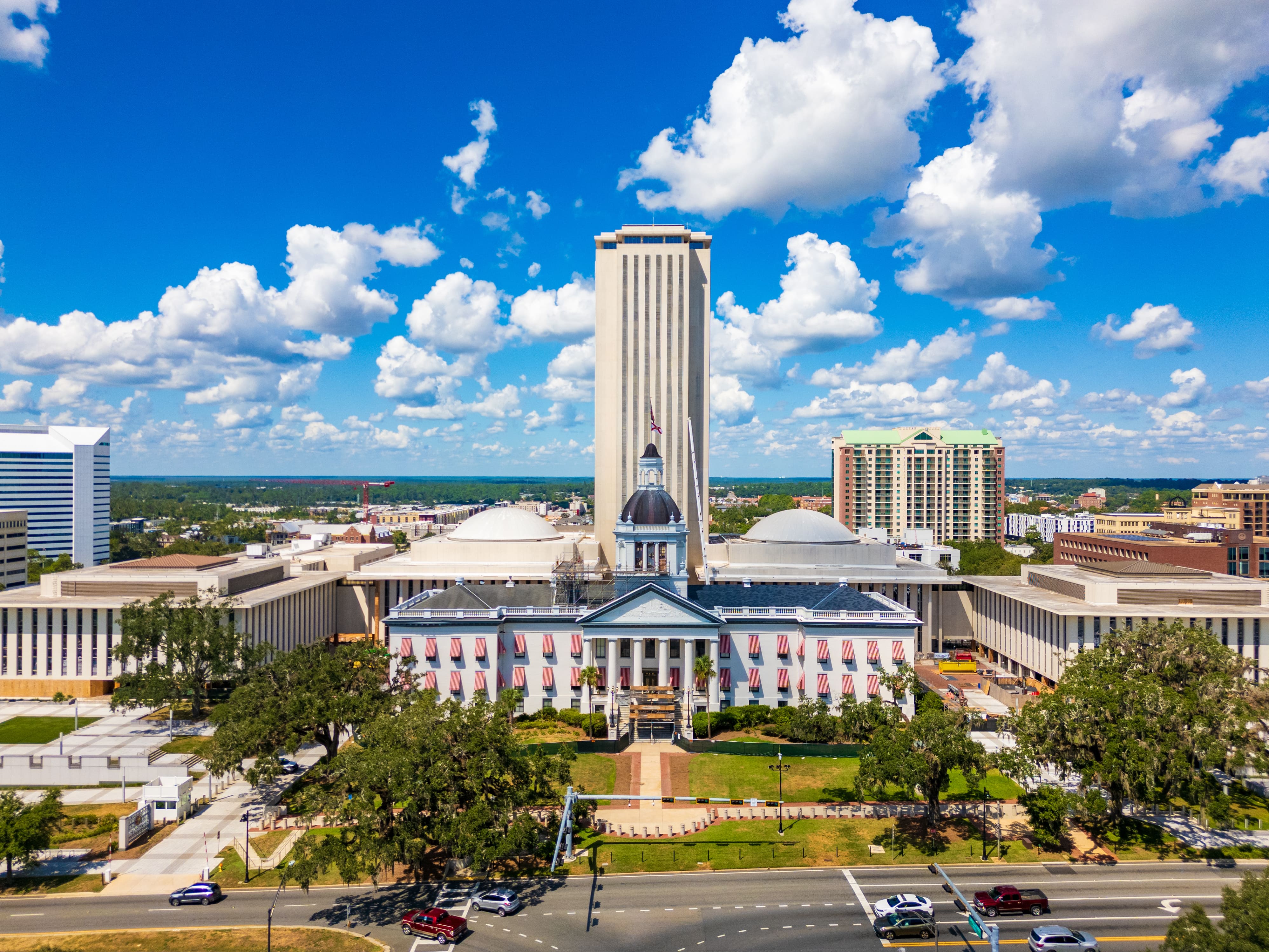 Aerial view of the Florida State Capitol building in Tallahassee under a bright blue sky, symbolizing the legislative process behind House Bill 913 impacting HOAs and condominiums.