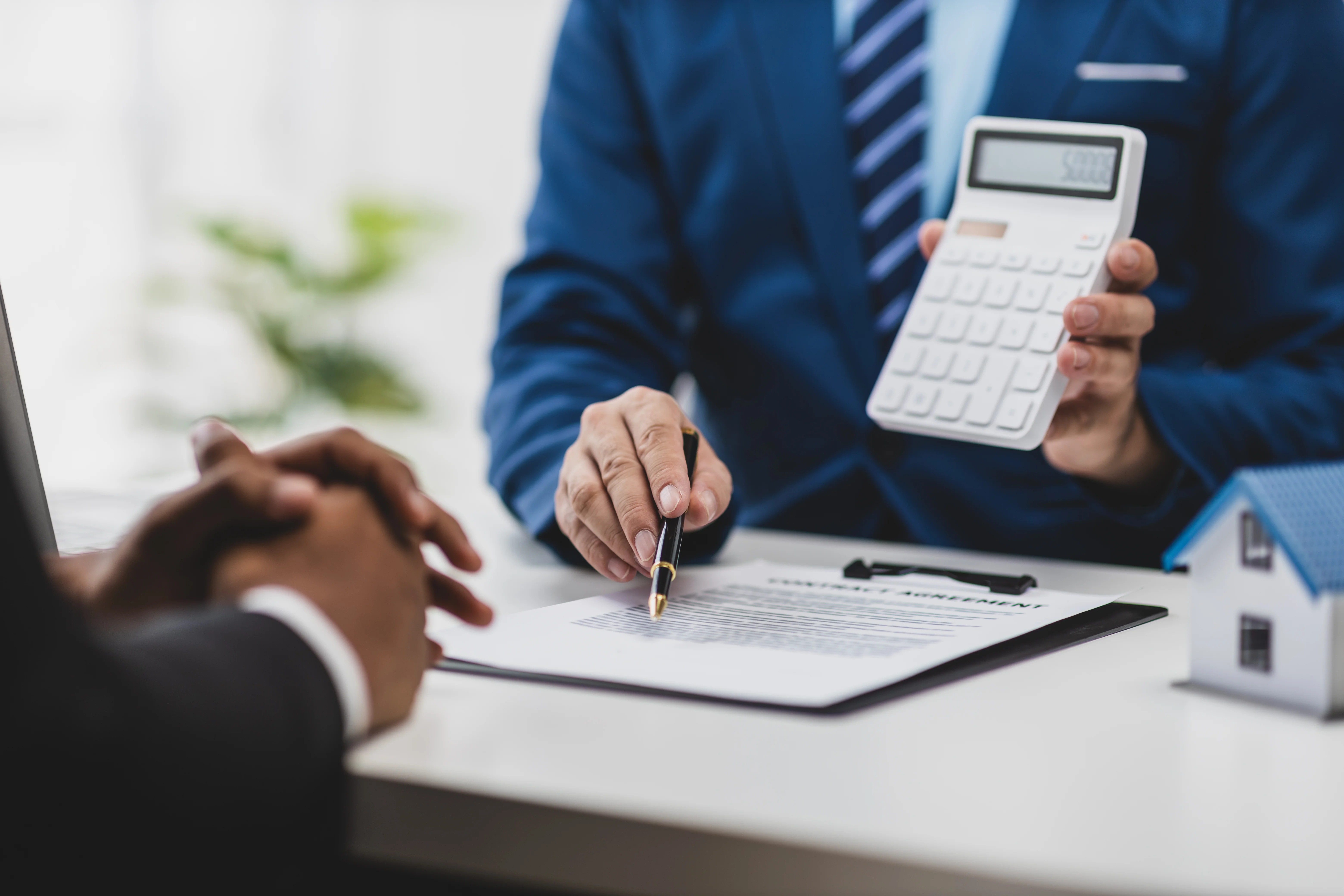 Landlord explaining prorated rent terms while holding a calculator and pointing to a rental contract.
