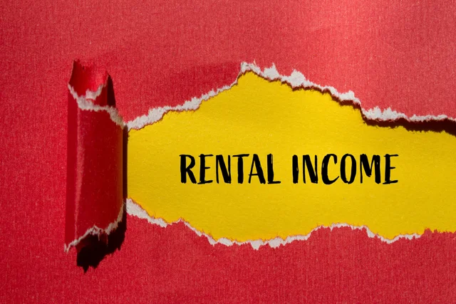 Red paper ripped to reveal “Rental Income” on yellow background, representing passive income and property cash flow strategy.